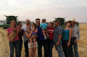 A family picture taken during wheat harvest. The picture includes Colleen and Rodney Jacobson, and her three older siblings and their families, which have since grown threefold. She now has 6 nieces and nephews, with another on the way!
