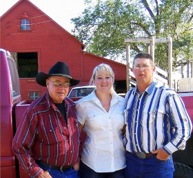Dawn's Dad, herself, and older brother, stop for a picture after a long day of moving bulls. 